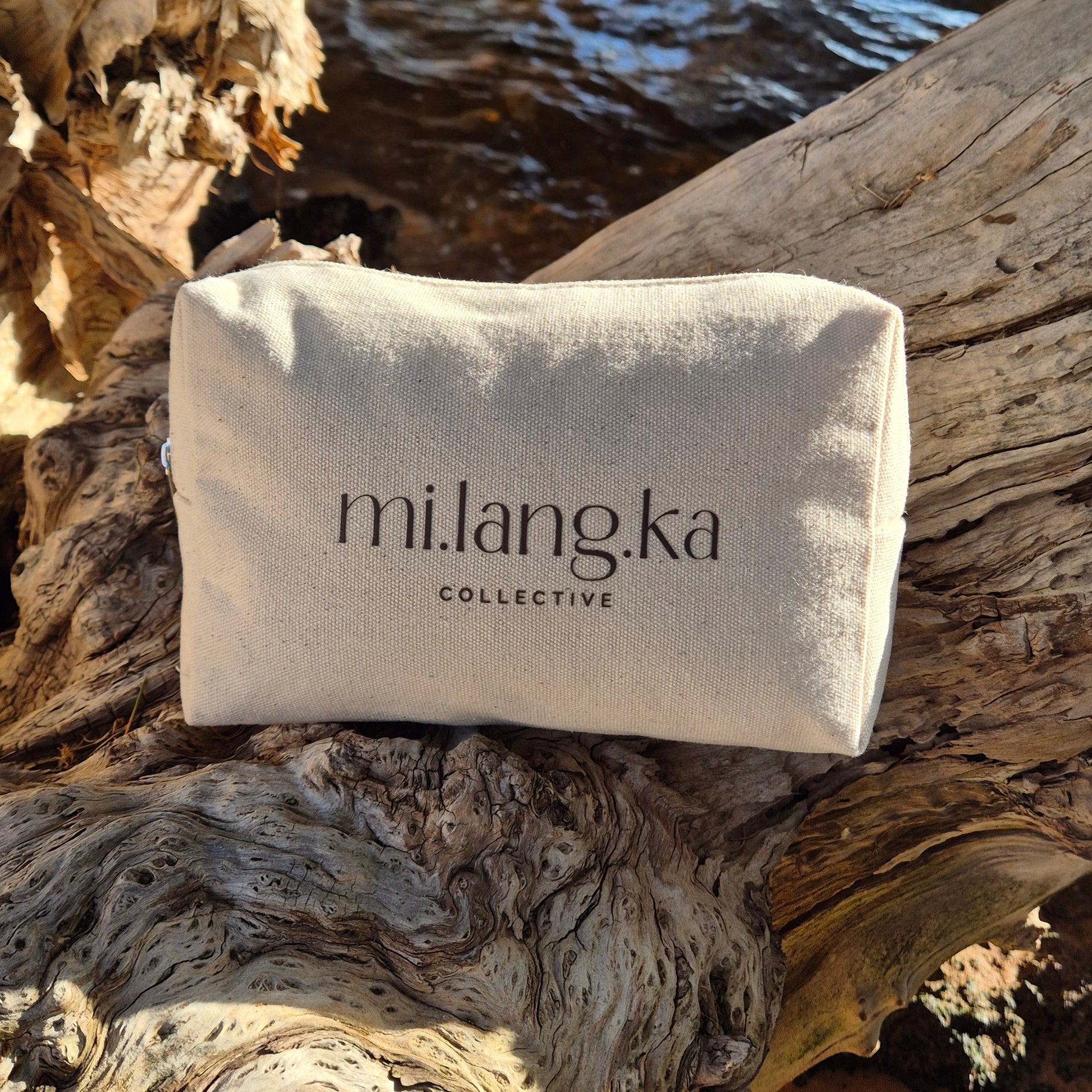 White bag with 'milangka' branding on a natural wooden background
