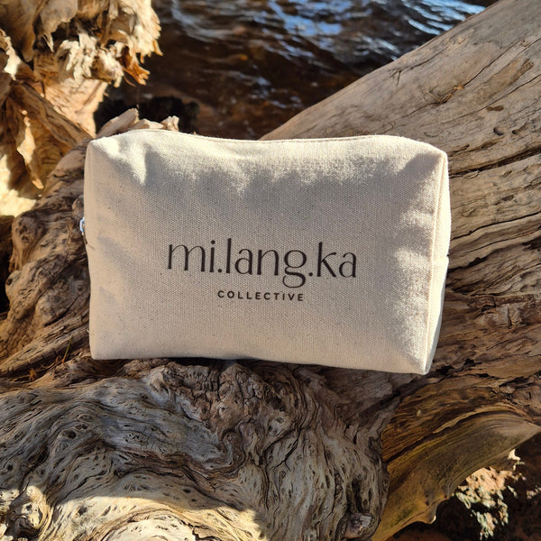 White bag with 'milangka' branding on a natural wooden background